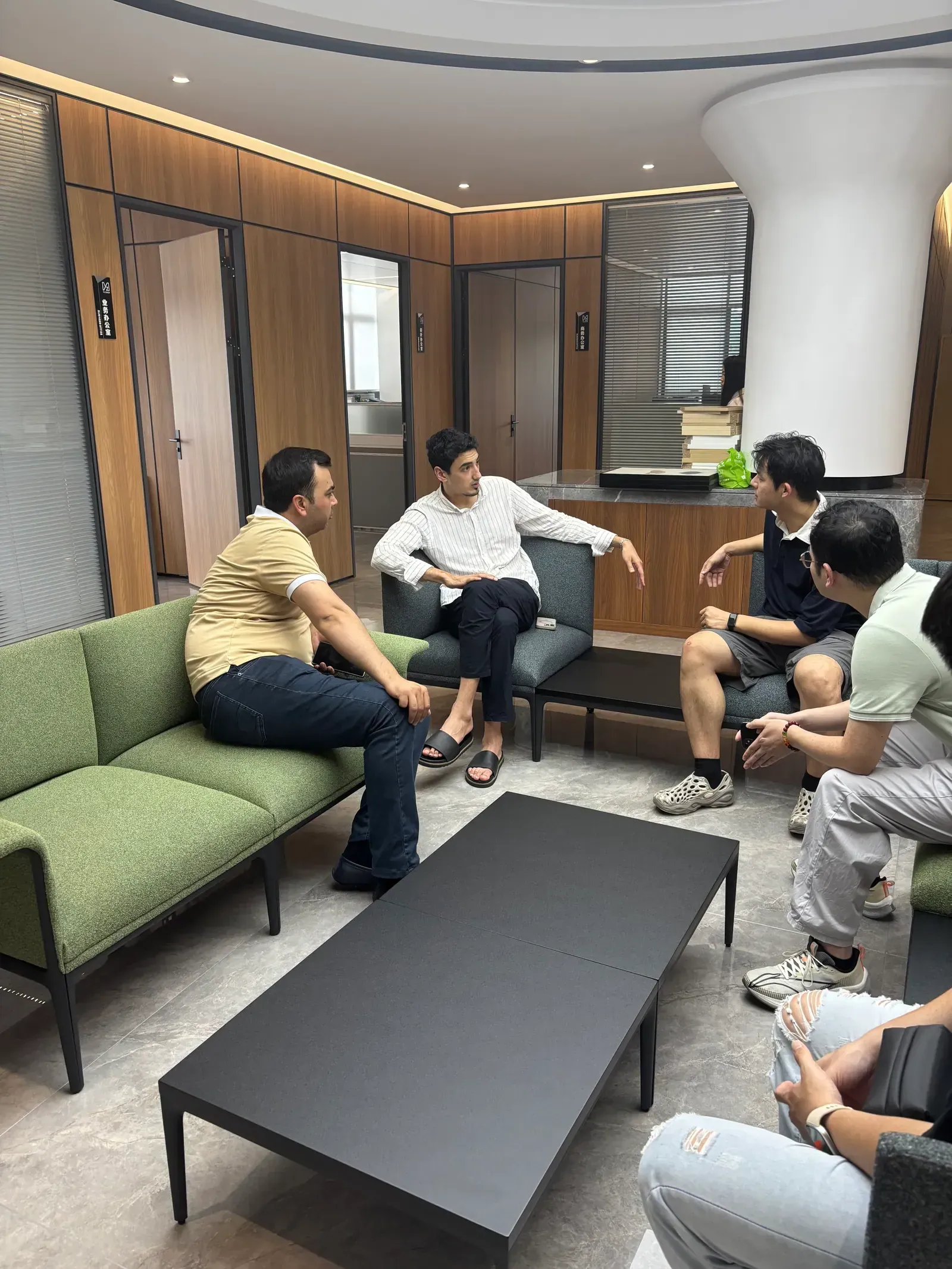 Yuzhen team discussing school furniture project requirements with visiting customers at the factory Yuzhen team discussing school furniture project requirements with visiting customers at the factory